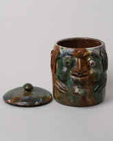 Detail view of the Apotropaia Large Head Jar on light color background.