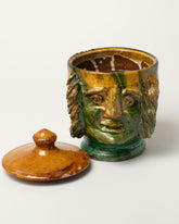 Detail view of the Apotropaia Lidded Head Jar Two on light color background.