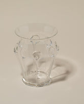 Closeup details of the Bollenglass Design Clear Drip Vase on light color background.