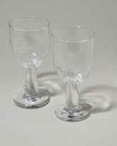 Closeup details of the Silje Lindrup Twisted Wine Glasses on light color background.