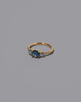 View from the side of the Sapphire Orion Ring on grey color background.