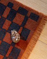 Styled image featuring the Curled-Up Cat Charm.