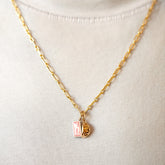 product_details::Hot Dog Chain Neclace, Dumpling Sauce Packet Charm and Steamed Dumpling Charm on model.