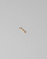 View from the side of the Lit Joint Charm on light color background.