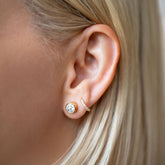 product_details::Allium Stud Earrings and Huggie Gold Diamond Snack Hoop Earrings on model.