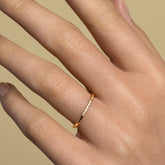 product_details::Gold Five Stone Dot Band on model.