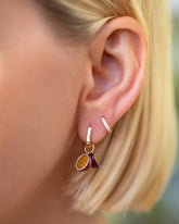 Halved Passion Fruit Charms paired with Gold Poppy Flower Bud Hoop Earrings and styled with Huggie Gold Diamond Snack Hoop Earrings on model.