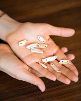 January Birthstone Pearl Pendant With Garnet, November Birthstone Pearl Pendant With Citrine, December Birthstone Pearl Pendant With Turquoise, March Birthstone Pearl Pendant With Aquamarine, August Birthstone Pearl Pendant With Peridot, July Birthstone Pearl Pendant With Ruby, May Birthstone Pearl Pendant With Emerald, February Birthstone Pearl Pendant With Amethyst, September Birthstone Pearl Pendant With Sapphire in hand on model.