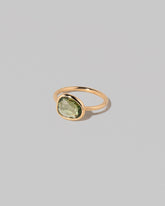 View from the side of the Gusher Green Sapphire Ring 004 on light color background.