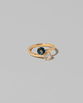 View from the side of the Sapphire & Diamond Union Ring on light color background.