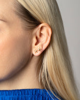 Shape Two Small Verve Six Point Star Stud Earrings on model.