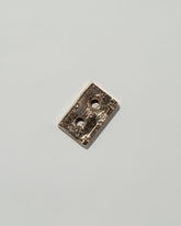 Pearce Objects Cast Bronze Mini Cassette Tape on light color background.