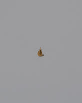 Closeup details of the Tear Stud Earring Single on light color background.