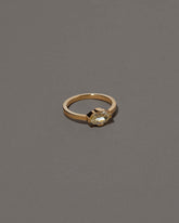 View from the side of the Beholden Ring on grey color background.