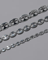 Closeup details of the CRZM Sterling Silver Yuba Mini Necklace, Sterling Silver Yuba Medium Necklace, and Sterling Silver Yuba Necklace on light color background.