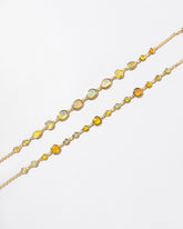 Ops Bracelet and Saturn Bracelet on light color background.