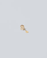 Closeup details of the Tea Bag Charm on light color background.