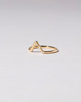 View from the side of the Gold White Diamond Five Stone Triangle Band on light color background.