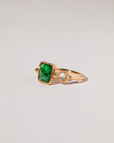 Emerald Moon Ring on light color background.