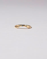 Gold Five Stone Blue Sapphire Mini Curve Band on light color background.