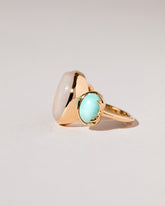 View from the side of the Manifestation Ring on light color background.