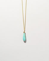 Turquoise Drop Pendant on light color background.