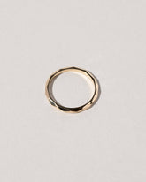 Gold 2mm Facet Band on light color background.