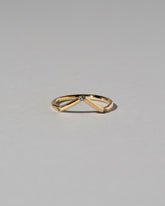 Gold Three Stone Blue Sapphire High Peak Band on light color background.