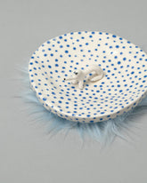 Closeup detail of the Eleonor Boström Furry Dog Plate on light color background.