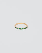 Gold Emerald Bar Baguette Band on light color background.