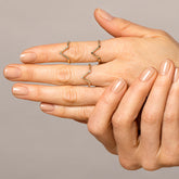 product_details::Gold White Diamond Three Stone Triangle Band, Gold Black Diamond Three Stone Triangle Band and Gold Blue Montana Sapphire Three Stone Triangle Bands on model.