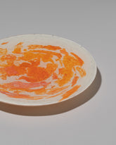 Closeup detail of the Stories of Italy Orange Nougat Dessert Plate on light color background.