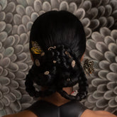 product_details::Styled image of the Cycle of Rebirth Earrings.