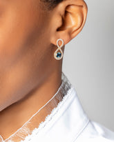 Ouroboros Earring on light color background.