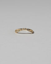 Gold Pavé Blue Sapphire Low Peak Band on light color background.