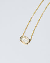 Grace Intaglio Seal Necklace on light color background.