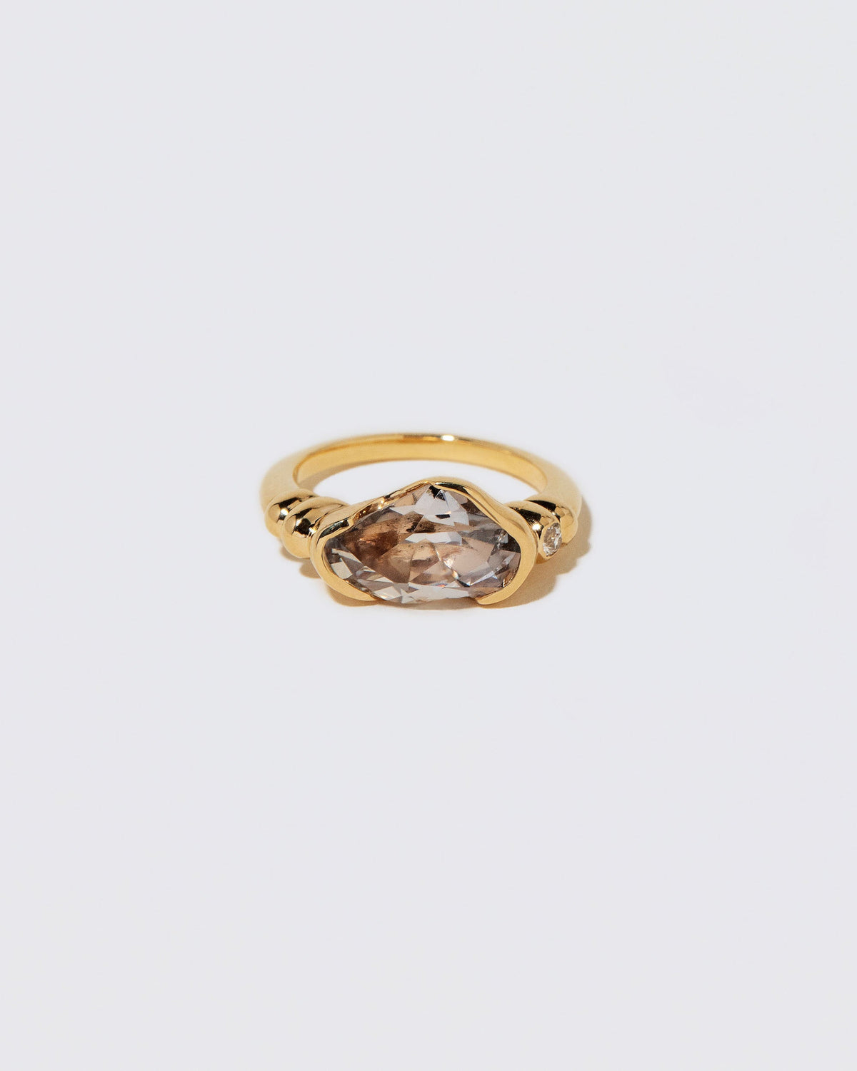 Custom by Mociun Top Notch Faceting Cut Madagascan Sapphire Ring on light color background.
