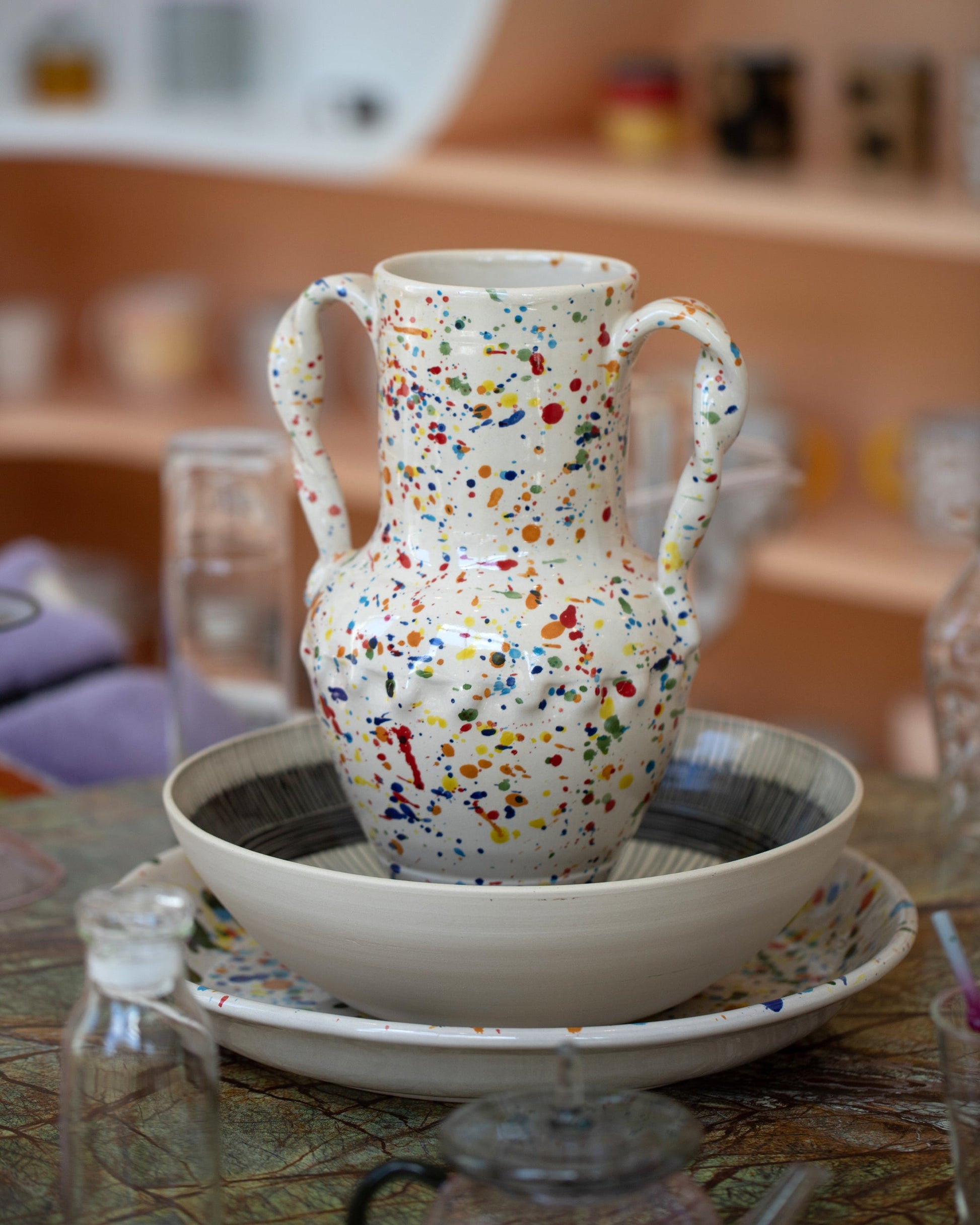 Styled image featuring the La Ceramica Vincenzo Del Monaco Large Colored Drops Ciarla Vase on light color background.