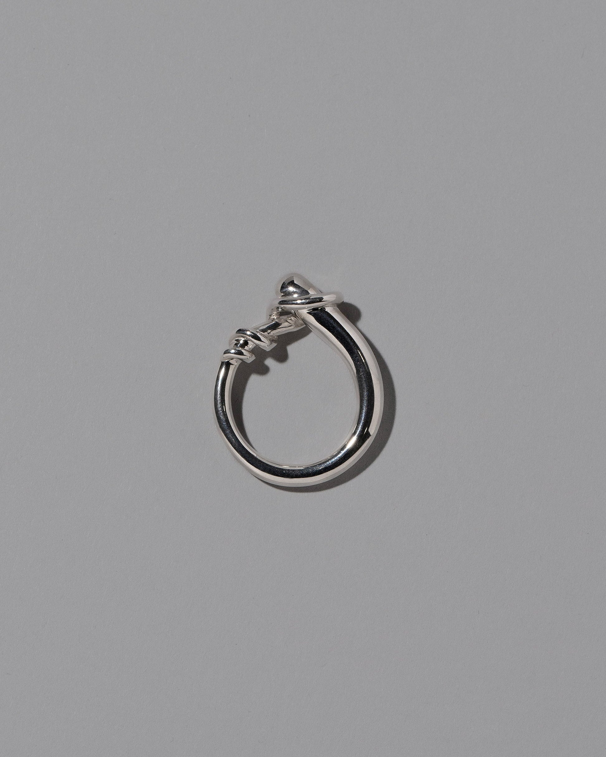 View from the side of the CRZM Sterling Silver Terrane Ring on light color background.