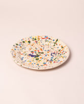 Closeup details of the La Ceramica Vincenzo Del Monaco Colored Drops Large Dish on light color background.