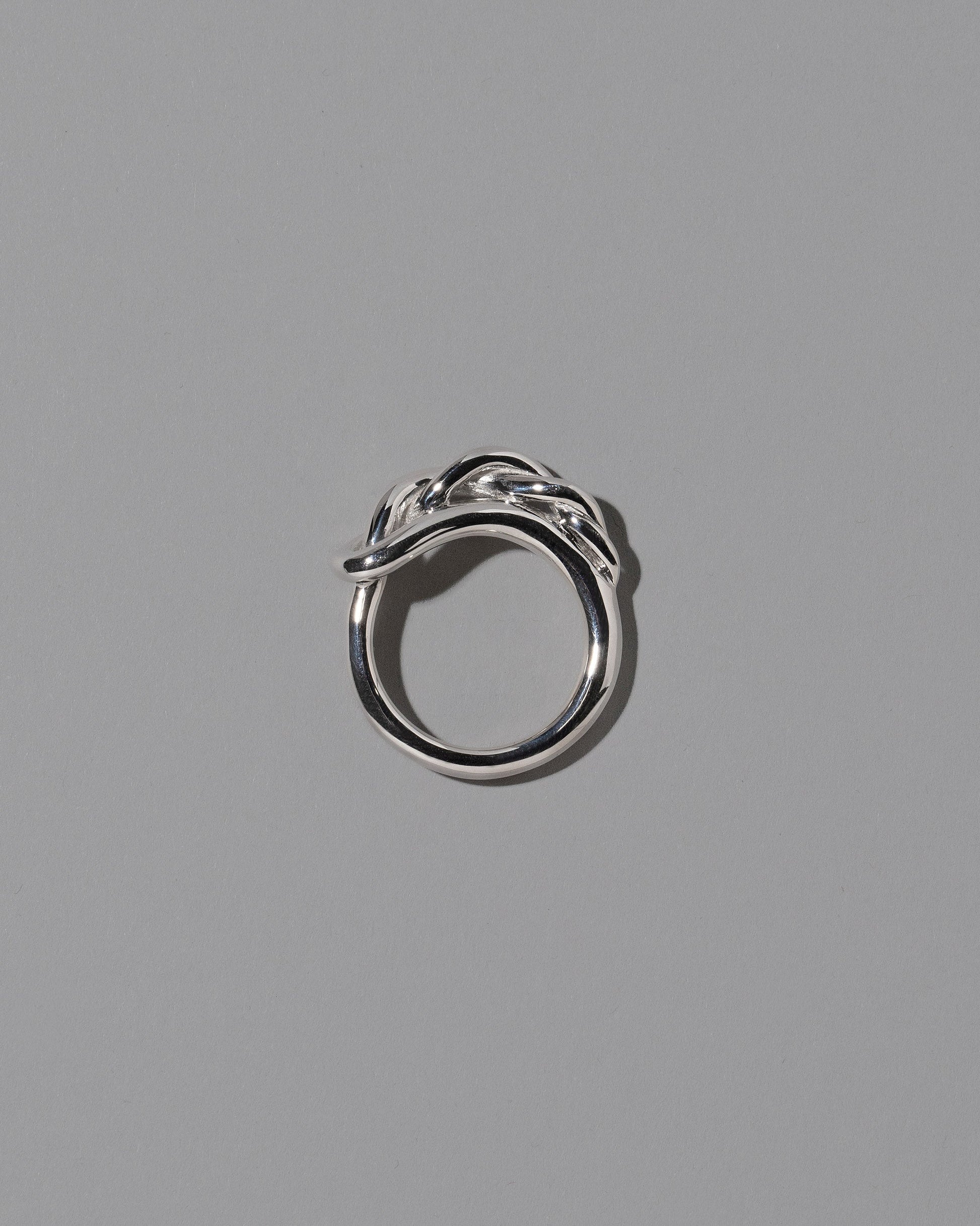 View from the side of the CRZM Sterling Silver Ophiolite Ring on light color background.