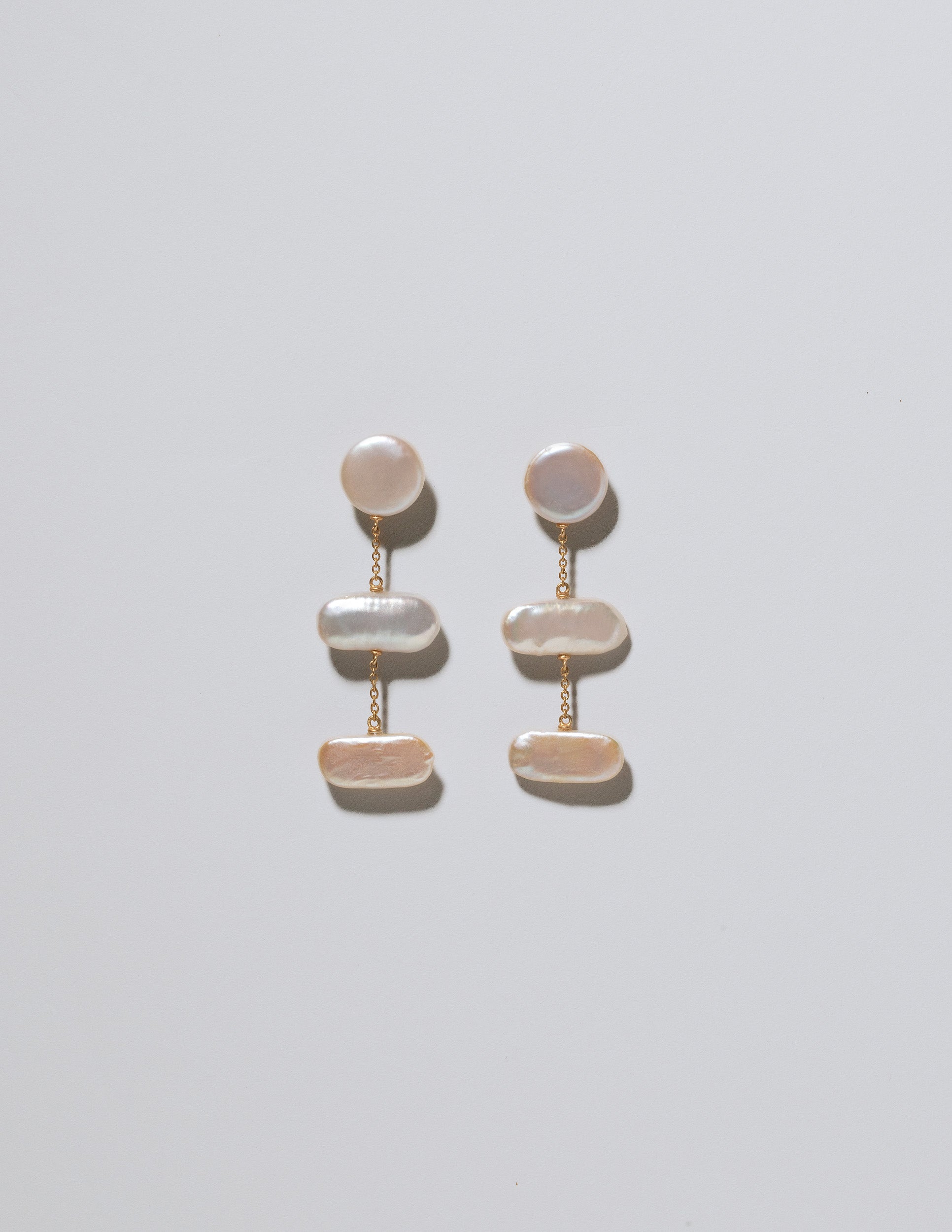 Kittiwake Earrings on light color background.