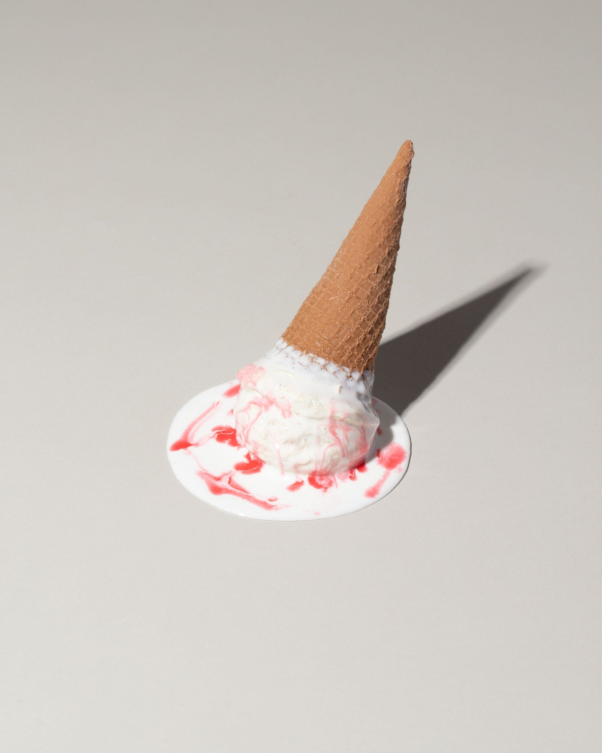 Spills Faux Strawberry Ice Cream Cone Spill on light color background.