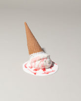 Spills Faux Strawberry Ice Cream Cone Spill on light color background.