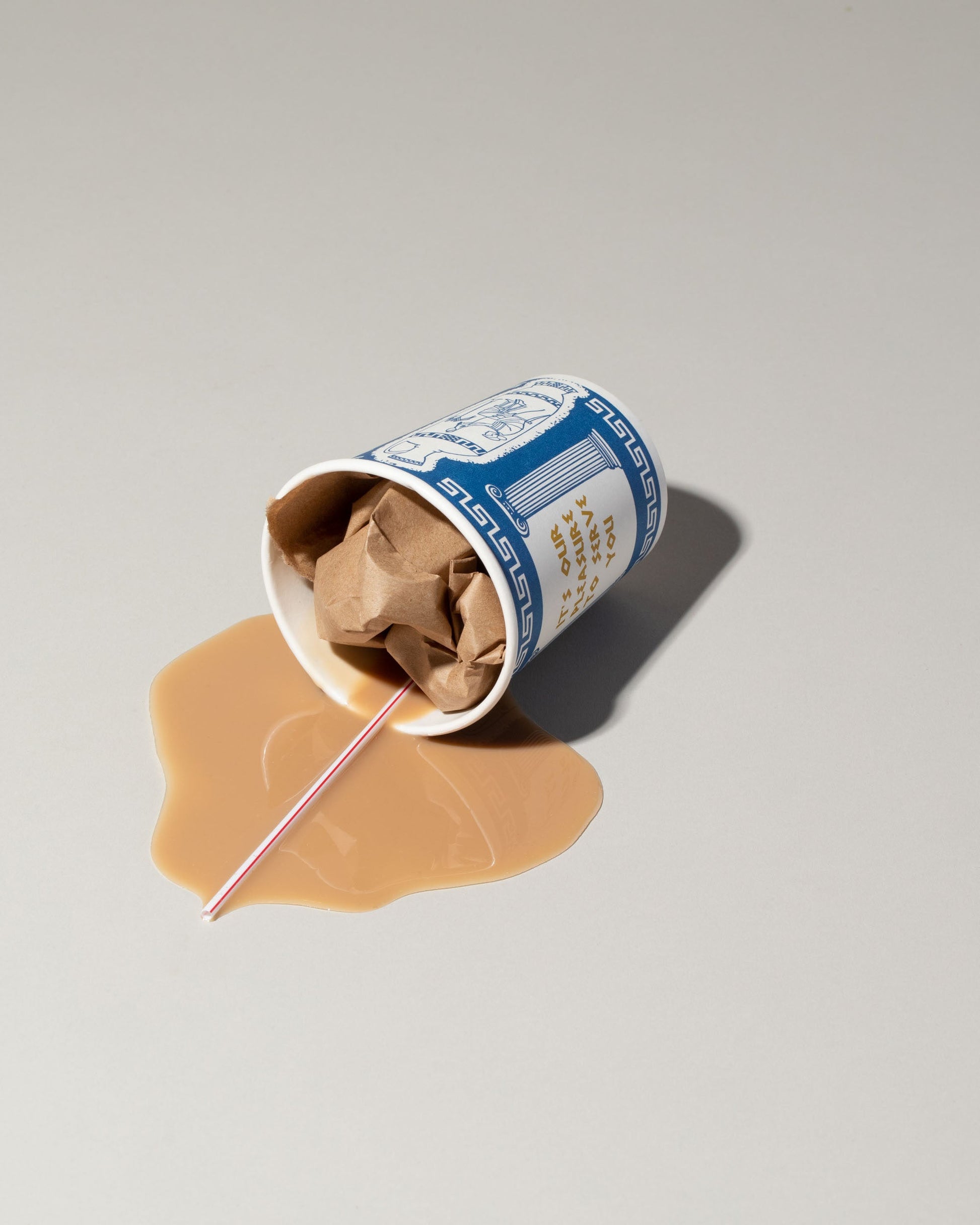 Spills Faux Diner Coffee To-Go Spill on light color background.