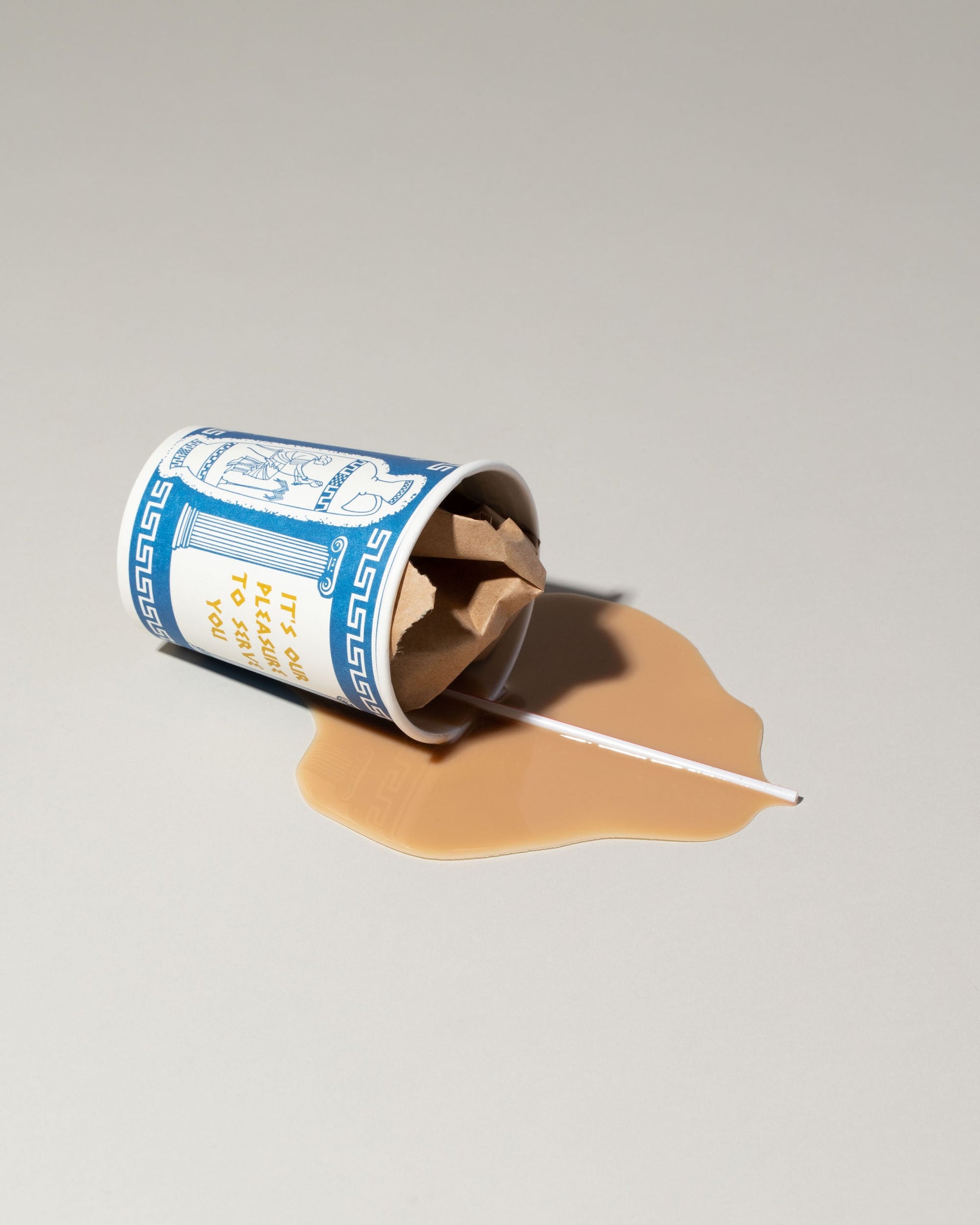 View from the side of the Spills Faux Diner Coffee To-Go Spill on light color background.