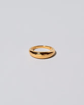 Gold 5.5mm Venus Band on light color background.