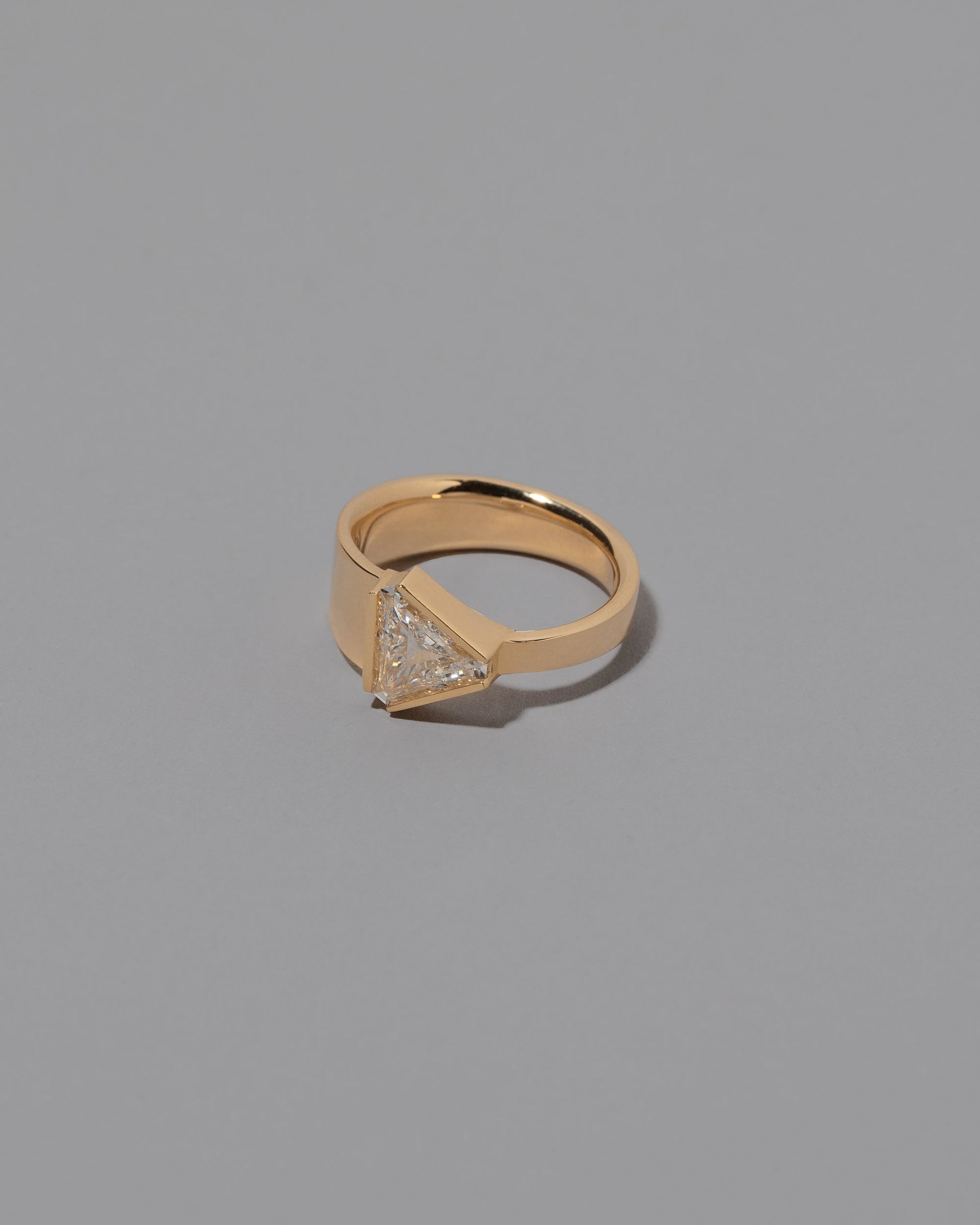 View from the side of the Tuck Ring on grey color background.