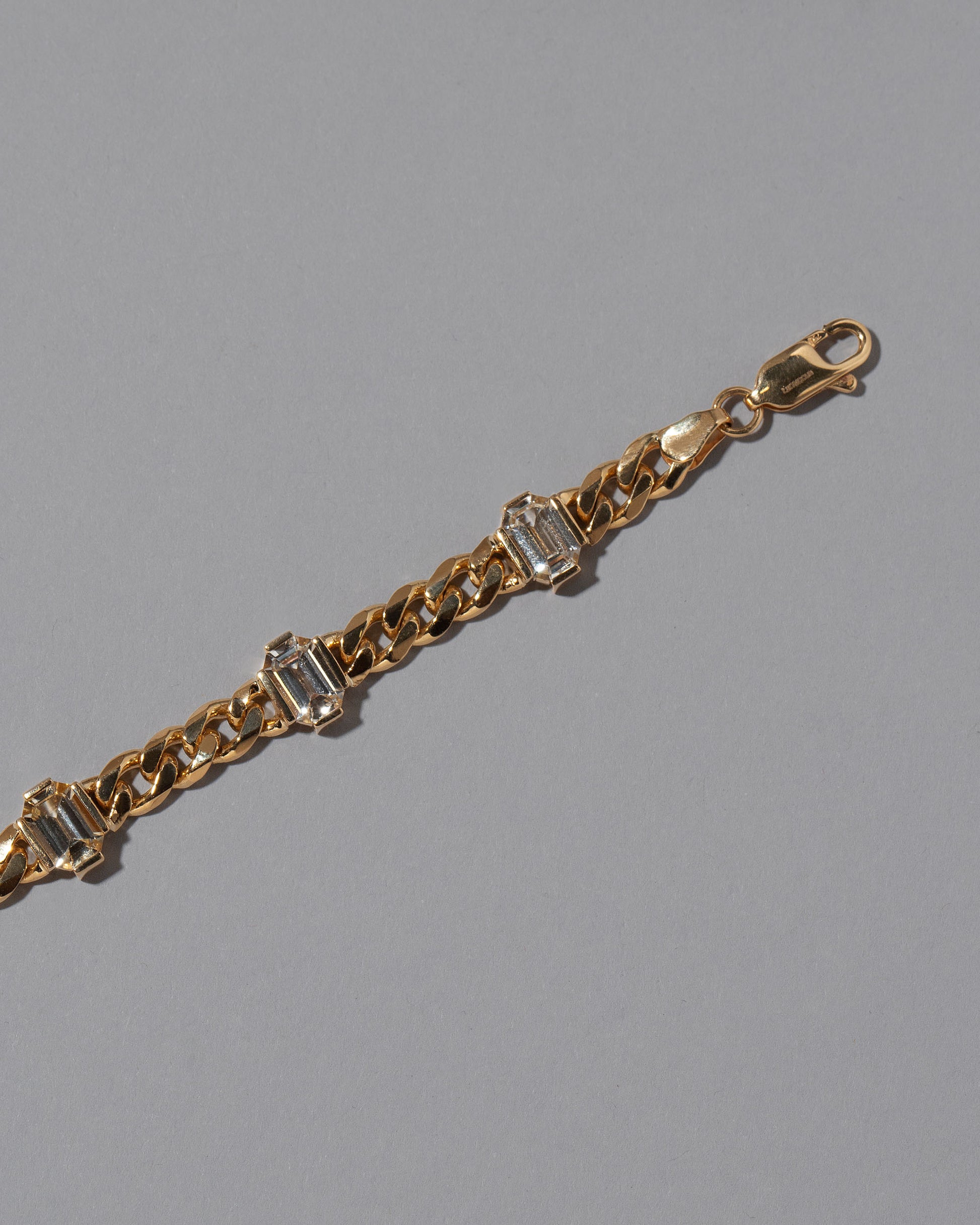 Detail view of the Envelop Bracelet on grey color background.