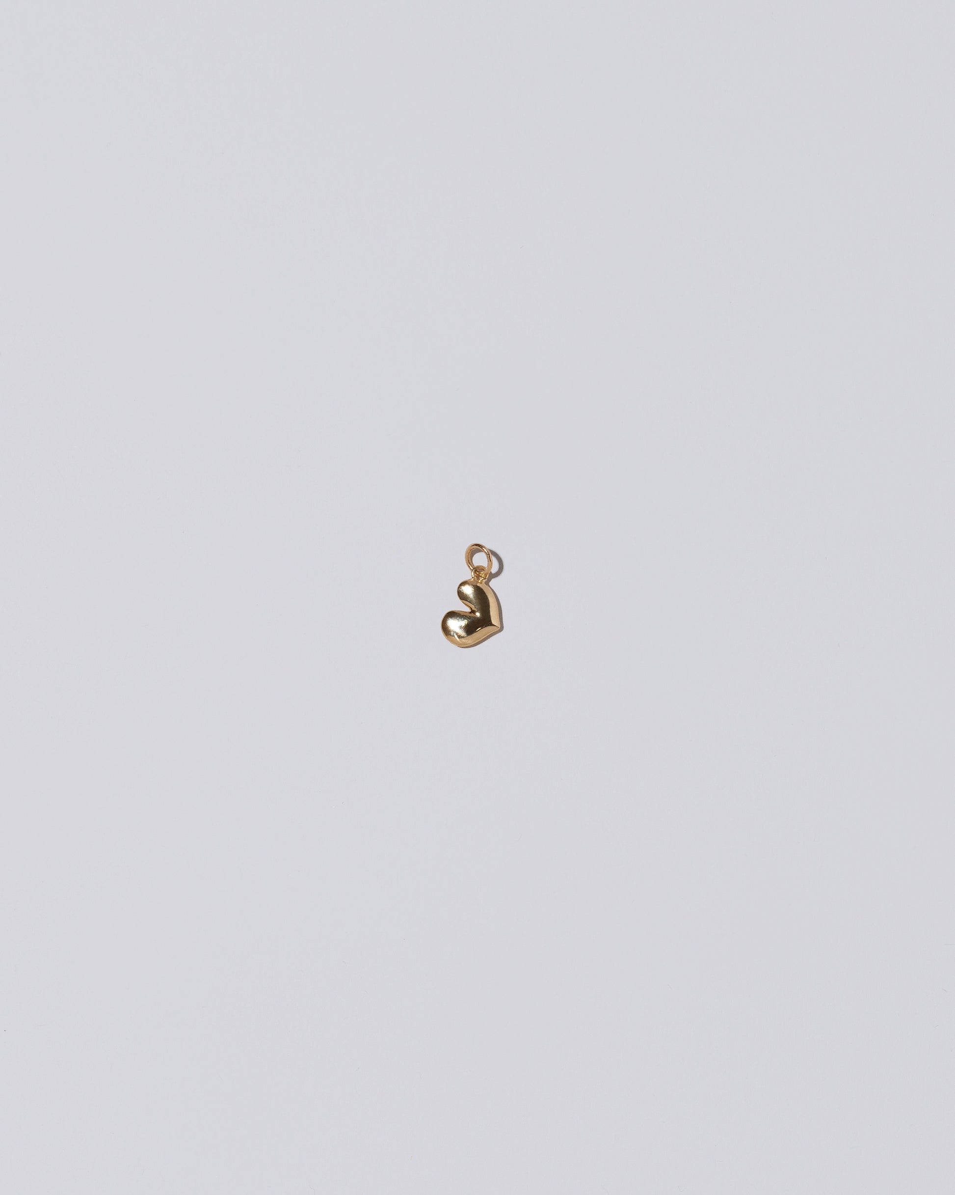 Thousand & One Night Heart Charm on light color background.